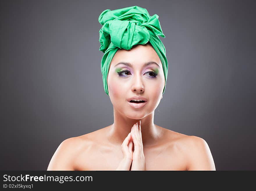 Hoping beautiful young woman with pink-green makeup in green hat