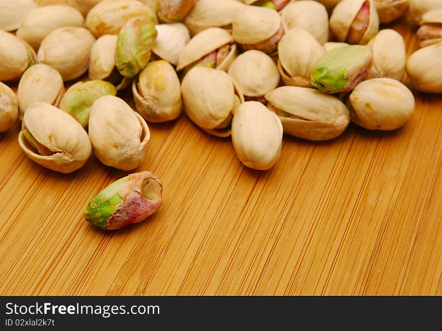 Pistachio nuts on wooden board