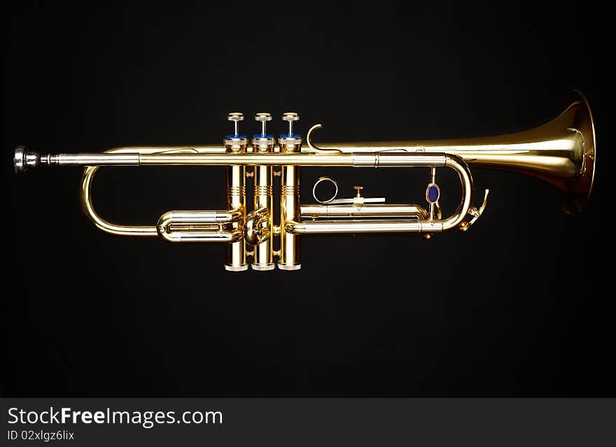 Trumpet over black background