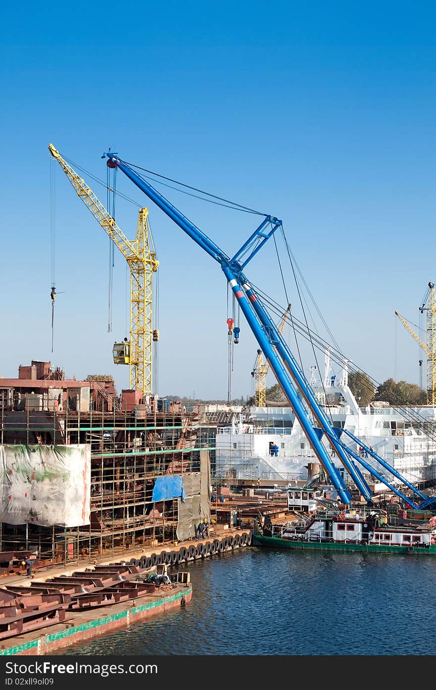 View of big cranes working in shipyard. View of big cranes working in shipyard