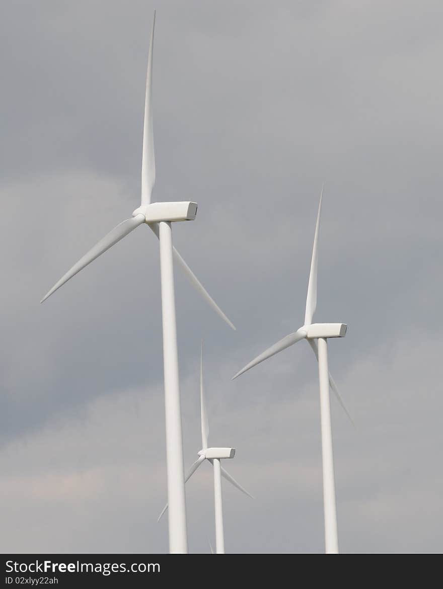 Windmill turbine blades rotating in a synchronized movement. Windmill turbine blades rotating in a synchronized movement.