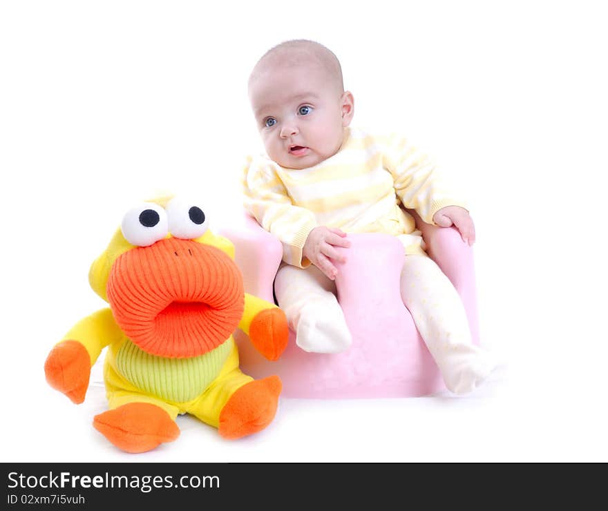 Photograph of cute baby with toy isolated against white