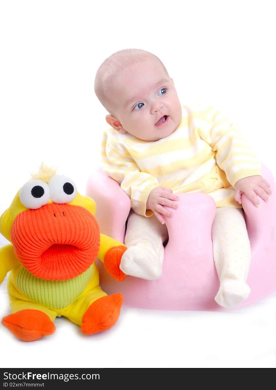 Photograph of cute baby with toy isolated against white