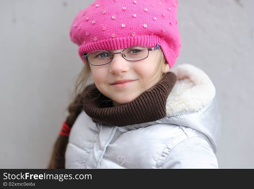 Adorable small girl in bright pink hat