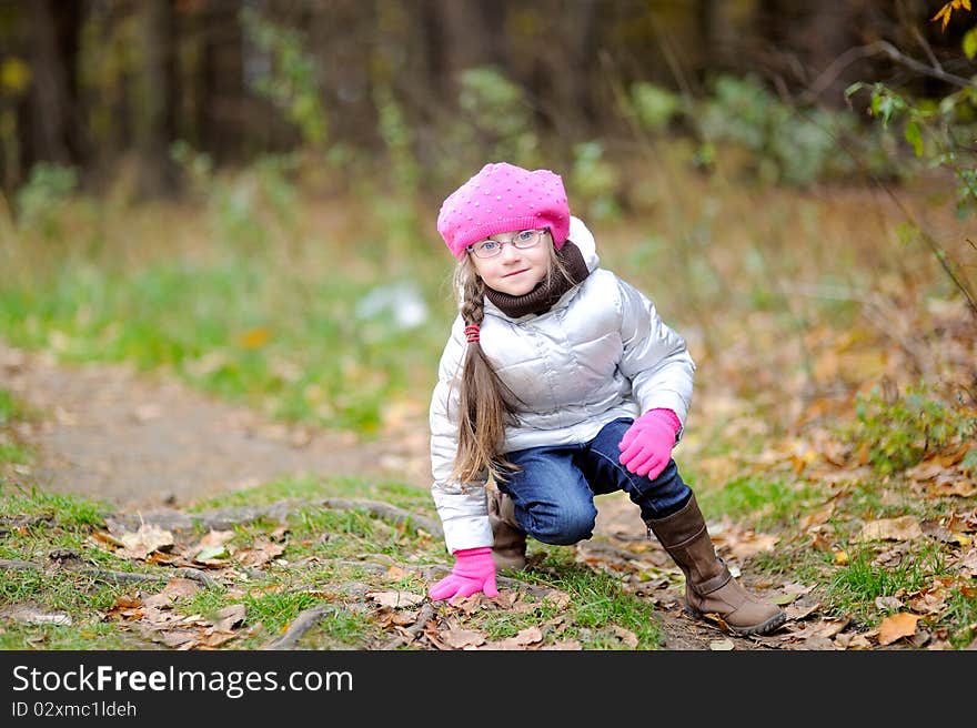 Adorable small girl in bright pink hat