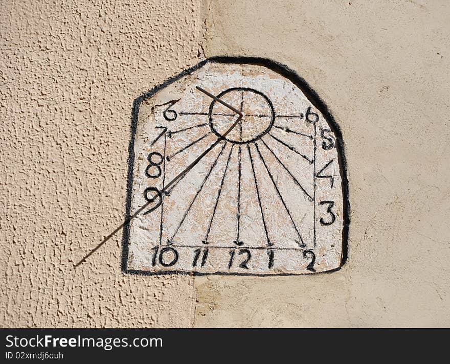 Sun Dial Clock on Cement Wall