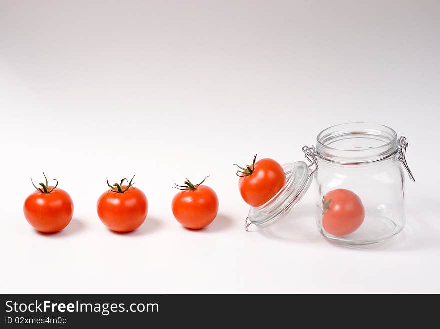 Happy tomatoes jumping in a jar