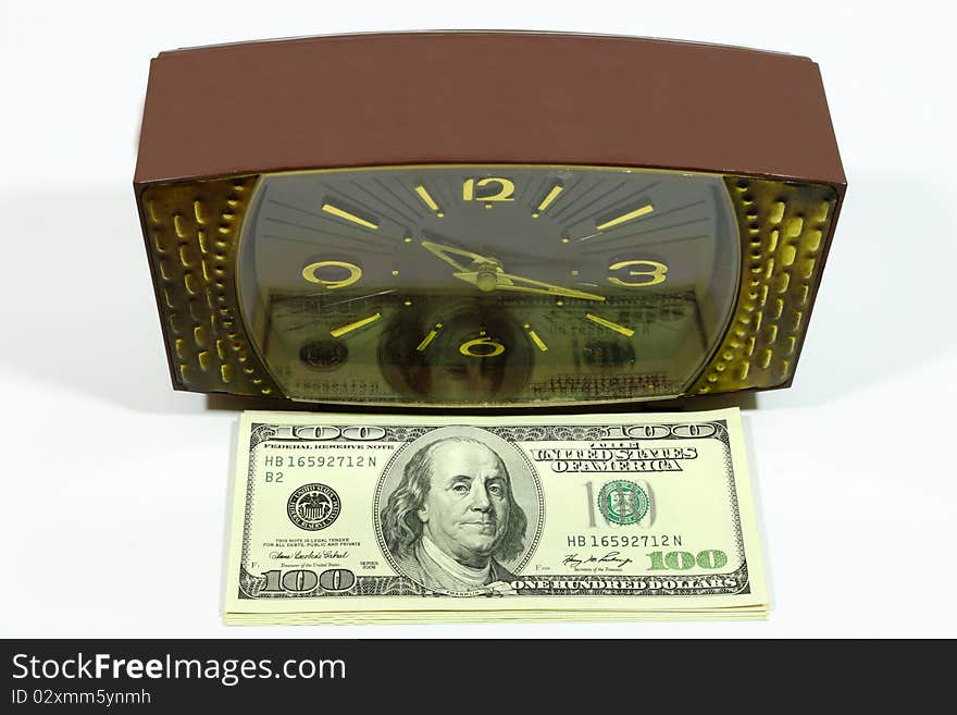 Reflection of dollars in hours symbolizes transformation of time into money. Reflection of dollars in hours symbolizes transformation of time into money.