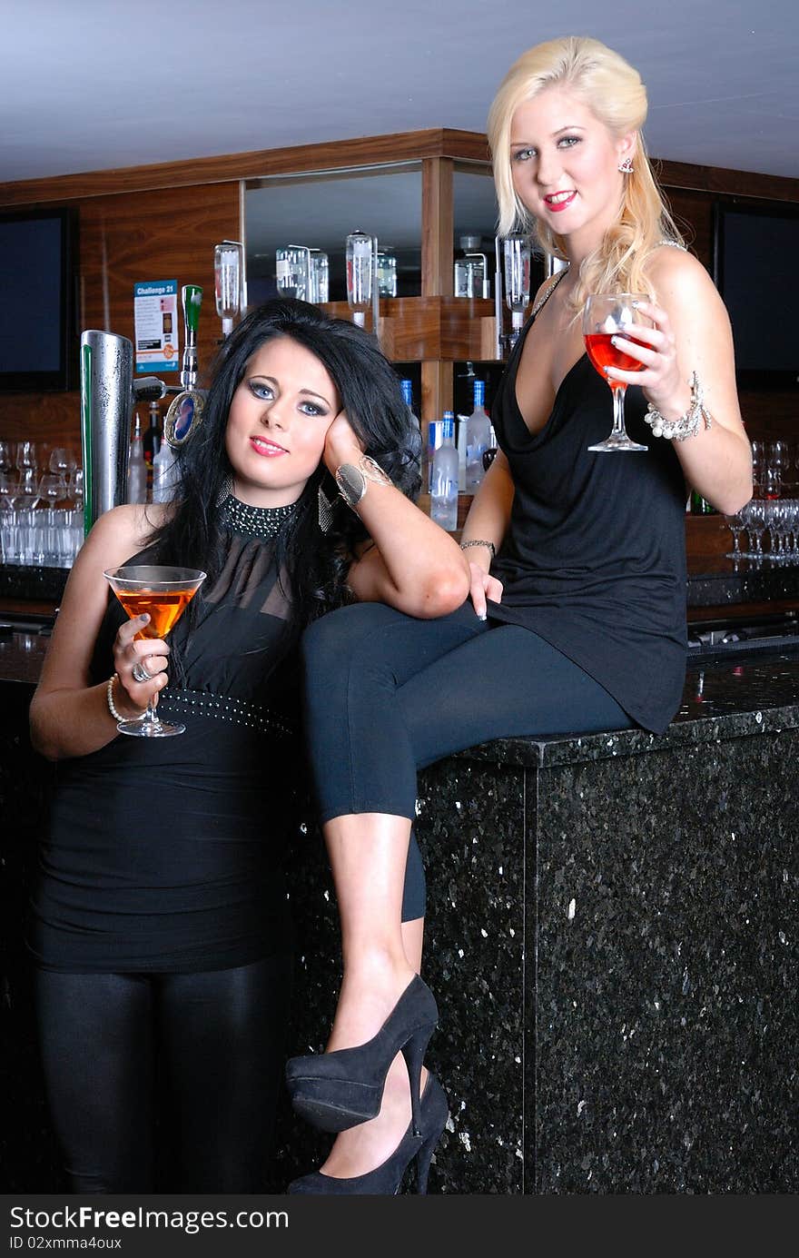 Photograph of two beautiful young girls in bar/club. Photograph of two beautiful young girls in bar/club