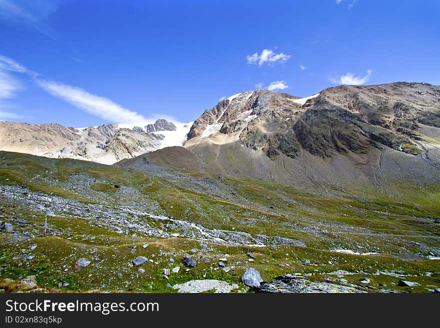 Mountains of the Valtellina with the glacier and stream