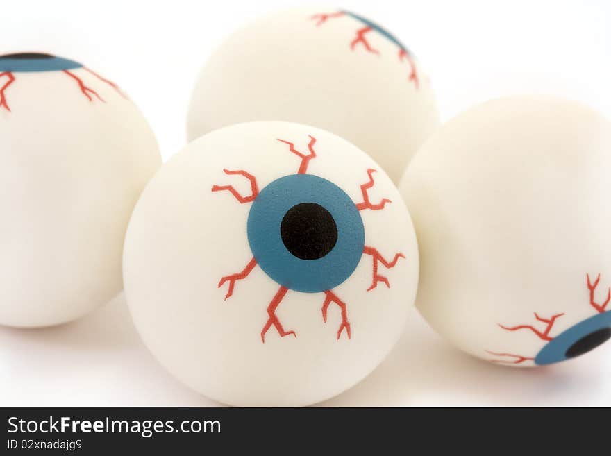 Background four rubber toy eyeballs isolated on a white background. Background four rubber toy eyeballs isolated on a white background