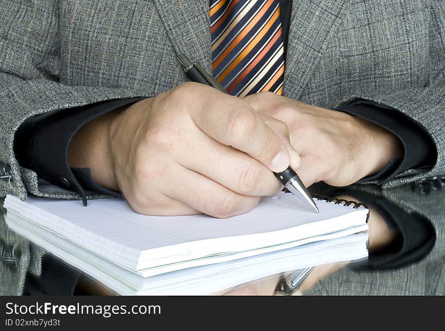 Men writing on the notebook and reflection