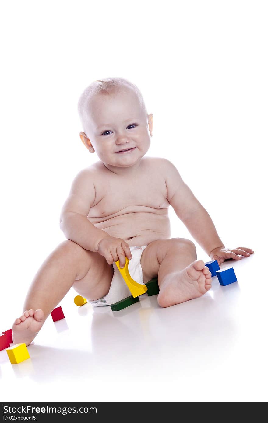 The kid plays with cubes on a white background