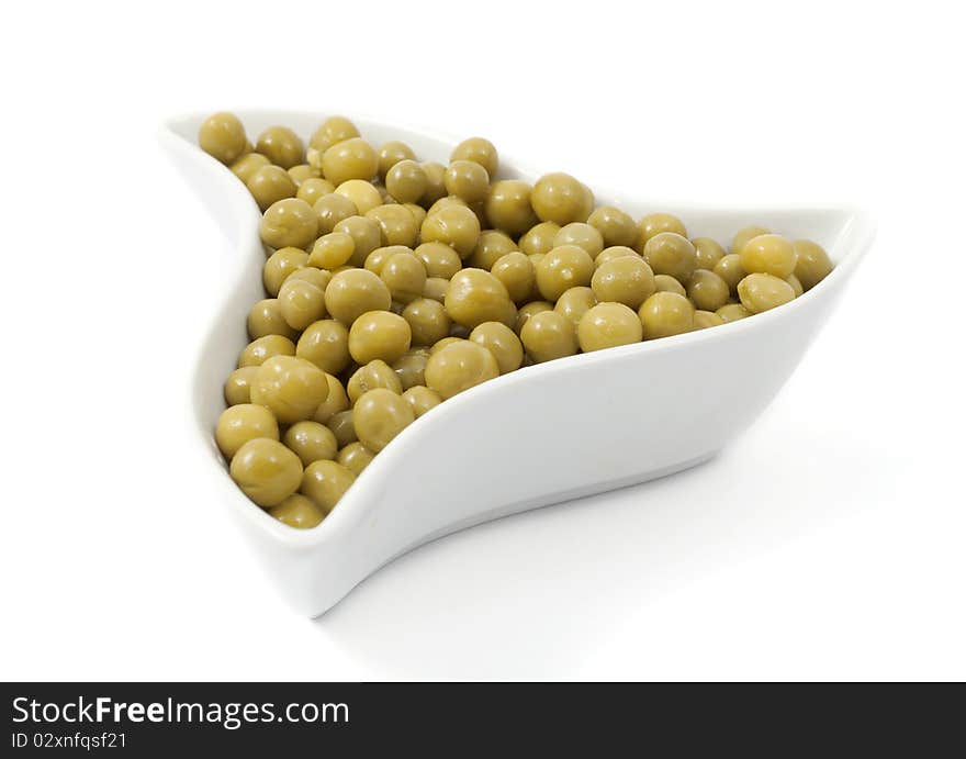 Green peas in a dish on a white background