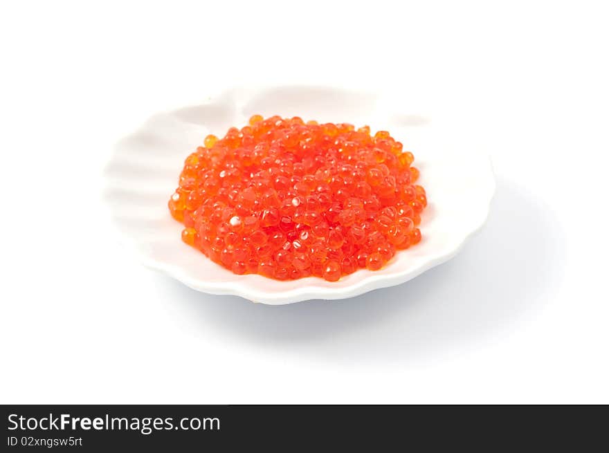 Red caviar on the plate on a white background