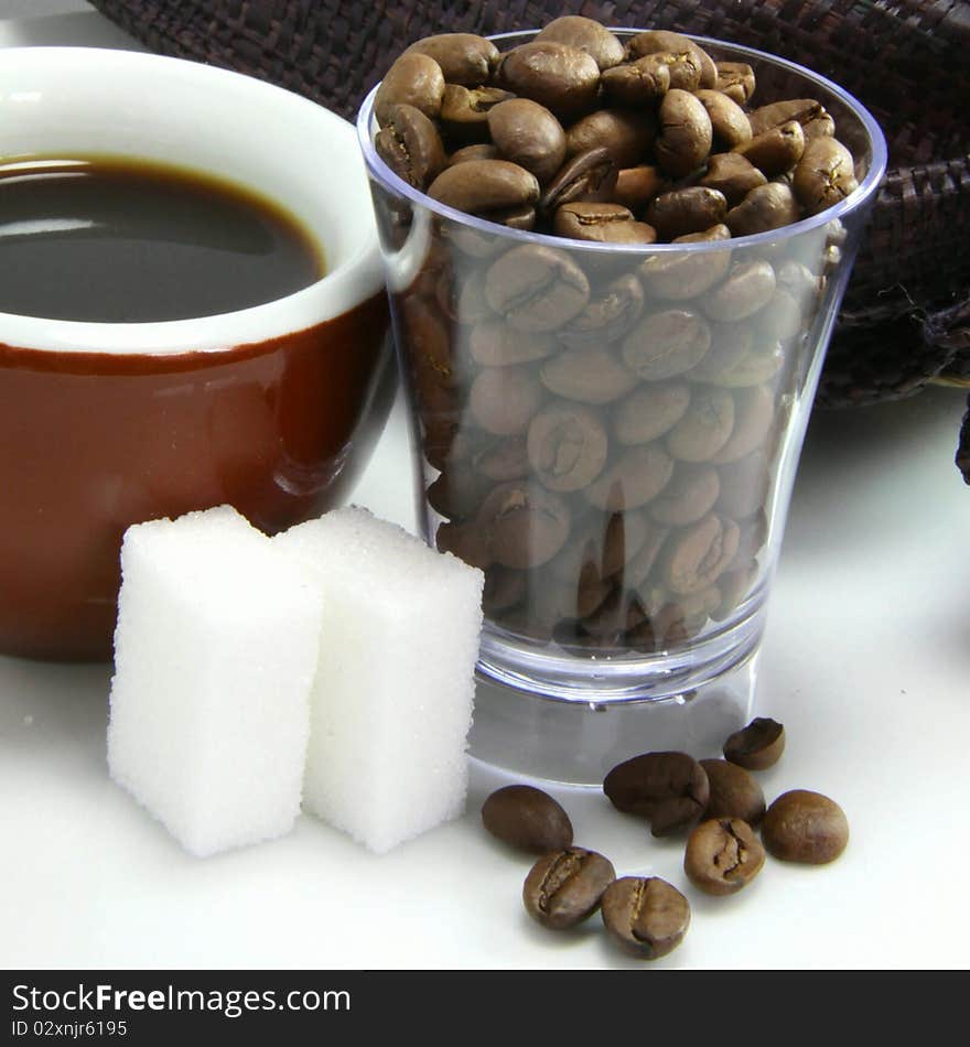 Black coffee, sugar and coffee beans. Black coffee, sugar and coffee beans