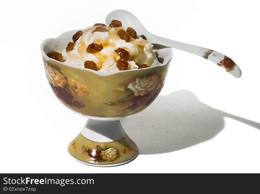 Cottage cheese with honey and raisin in a beautiful porcelain vase. Cottage cheese with honey and raisin in a beautiful porcelain vase