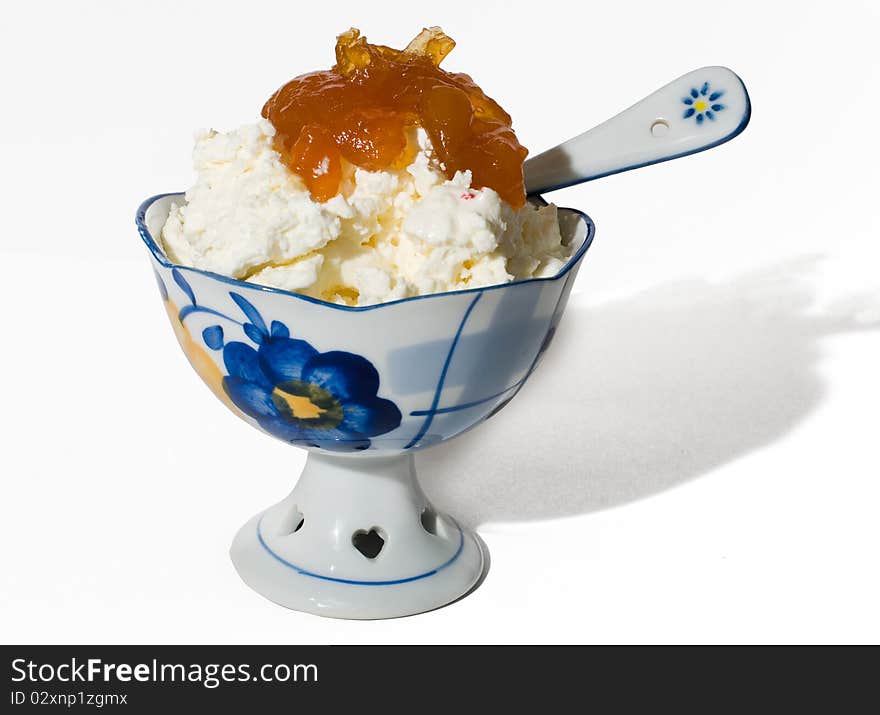 Cottage cheese with jam from apricots in a beautiful porcelain vase. Cottage cheese with jam from apricots in a beautiful porcelain vase