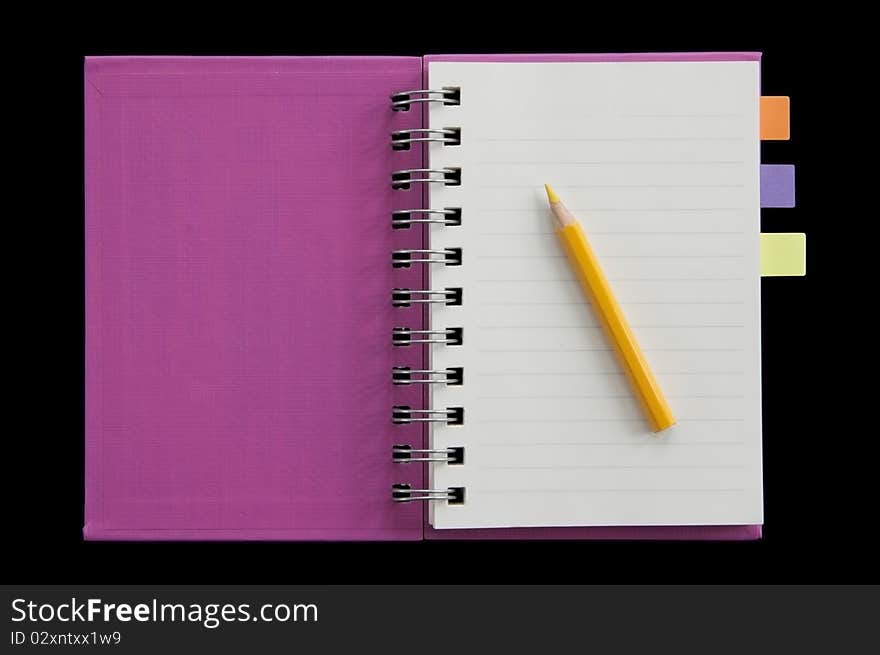 Small notebook fist page open and yellow pencil as black background