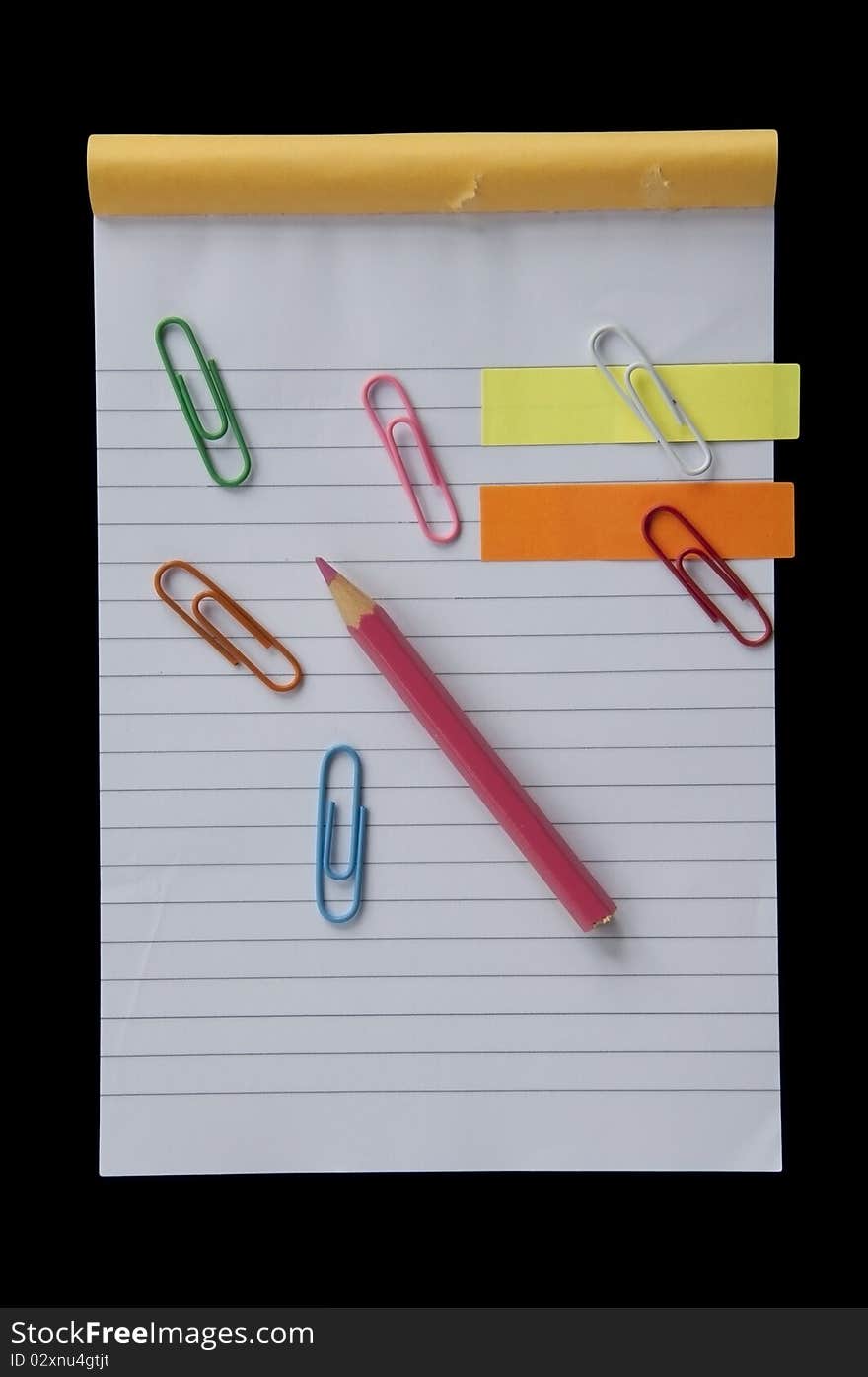 Mini notebook and colorful clip as black background