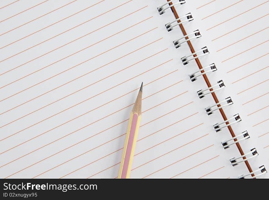 Top view of notebook and pencil