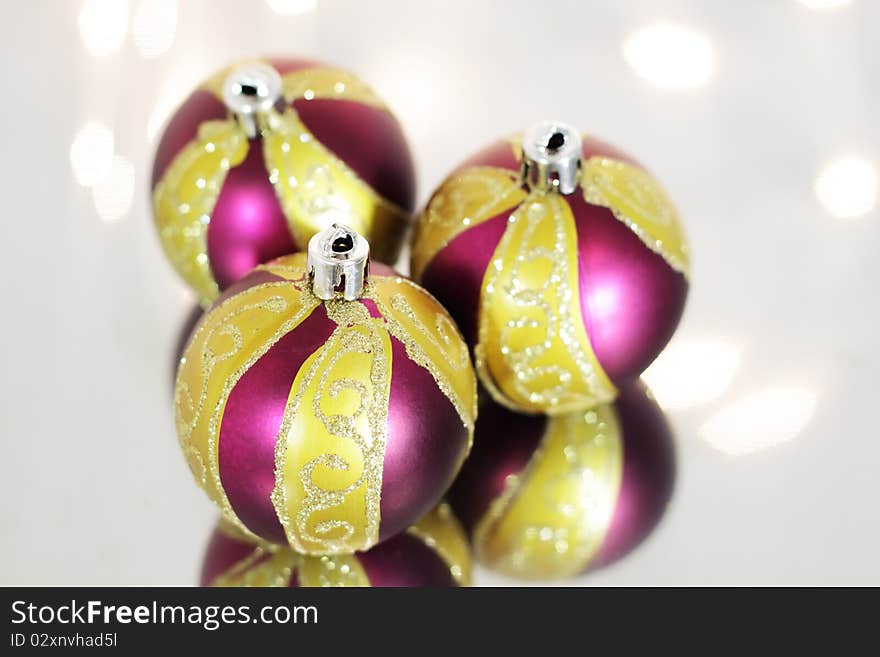 Three red Christmas ball on a background of lights