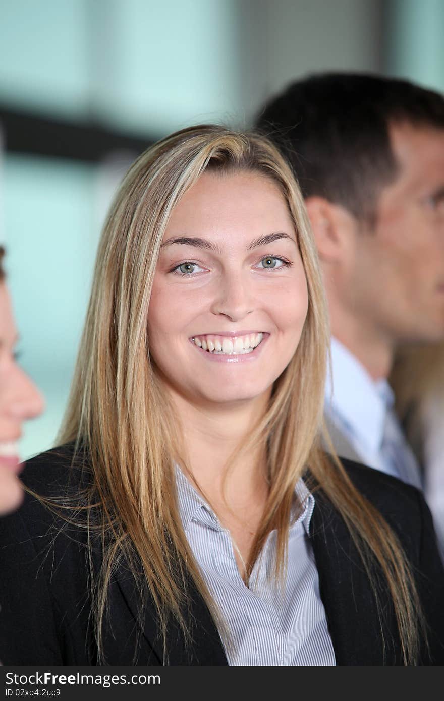 Businesswoman standing in front of group in the office. Businesswoman standing in front of group in the office