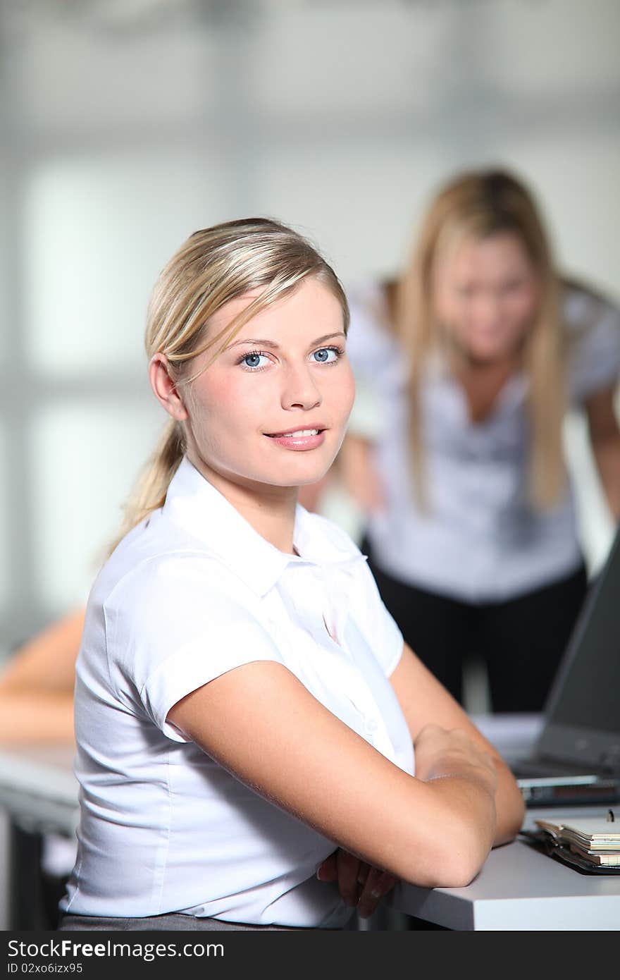 Beautiful businesswoman sitting at her desk. Beautiful businesswoman sitting at her desk