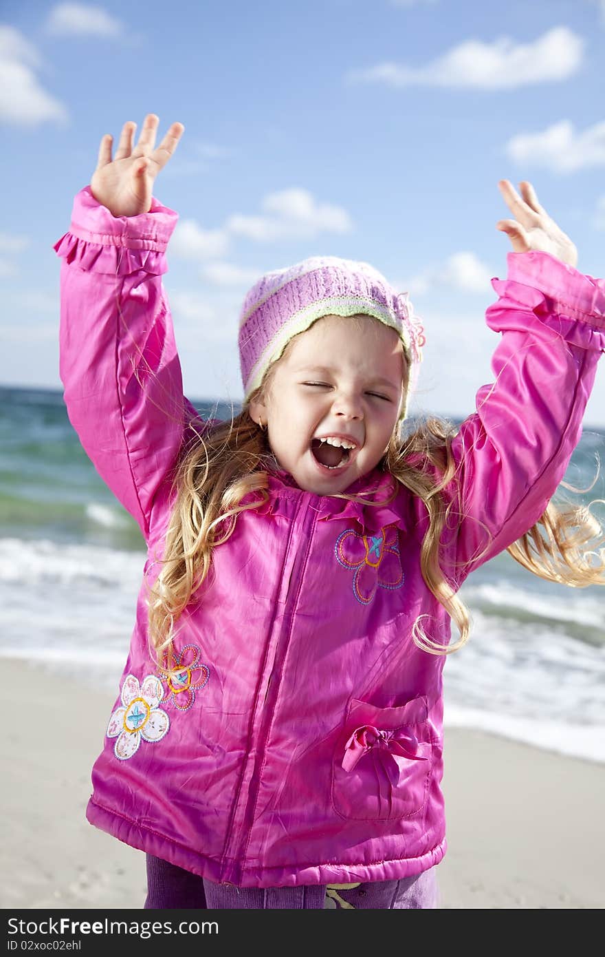 Cute young girl having fun on the beach