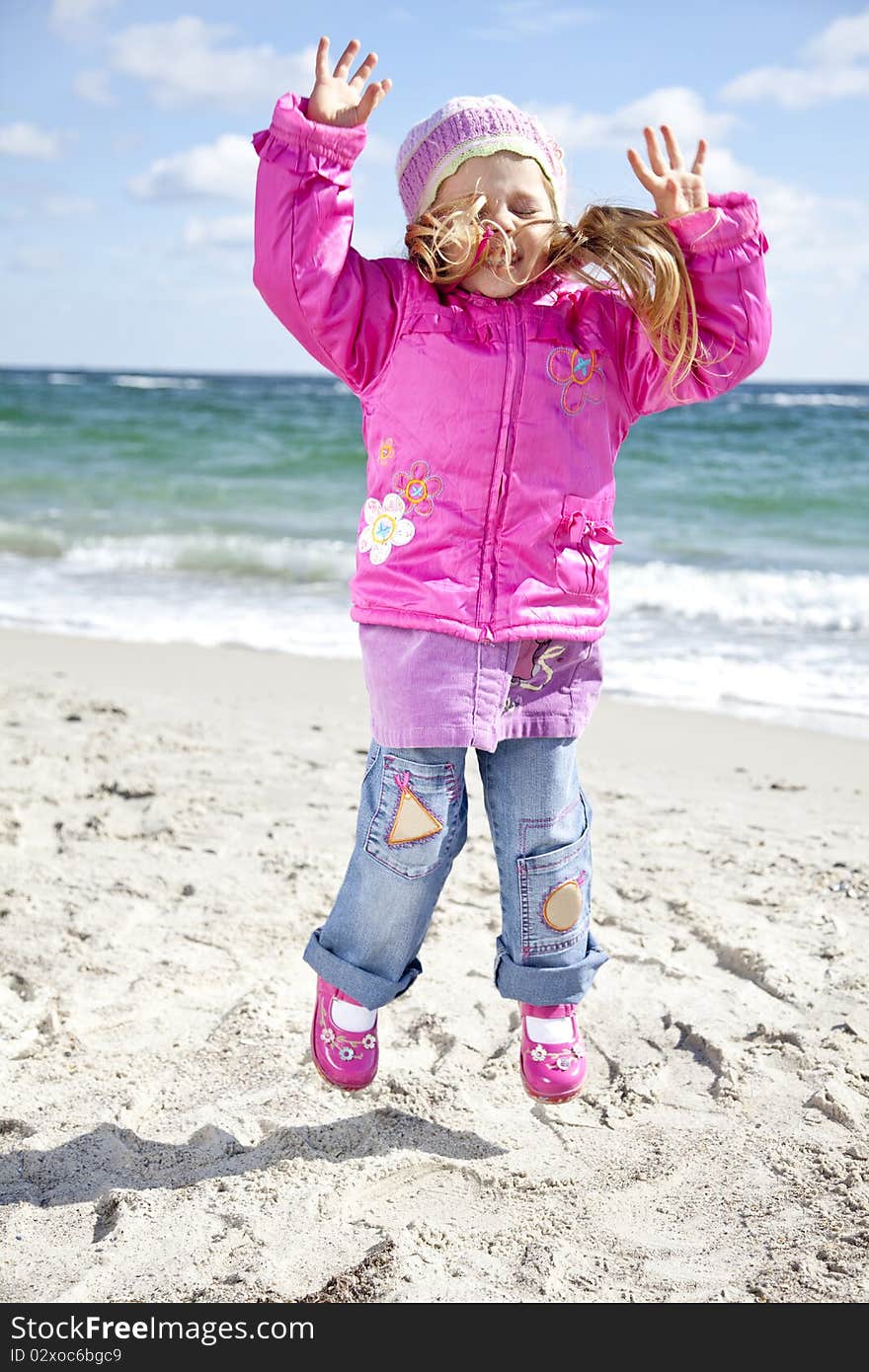 Cute young girl having fun on the beach