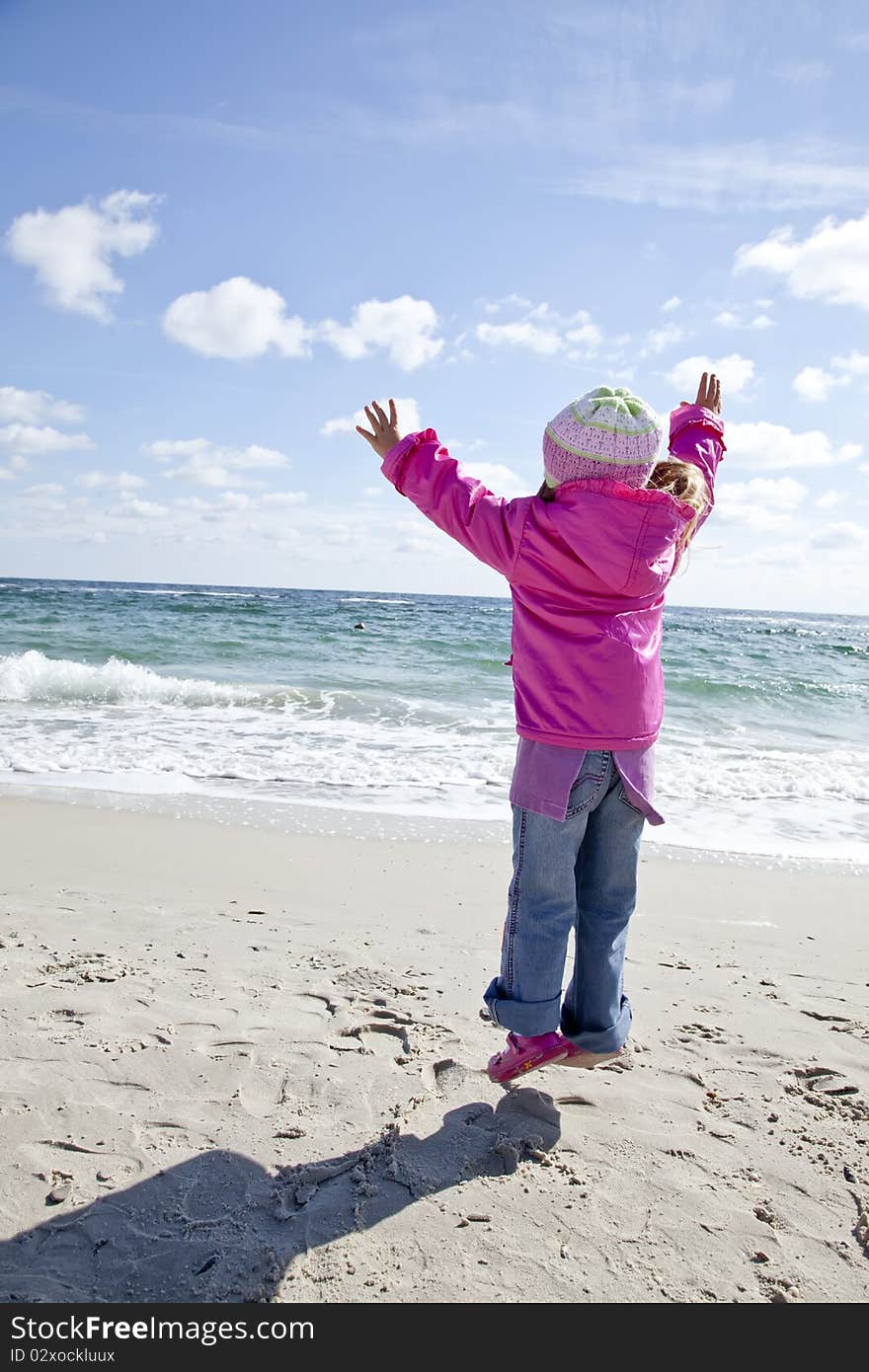 Cute young girl having fun on the beach