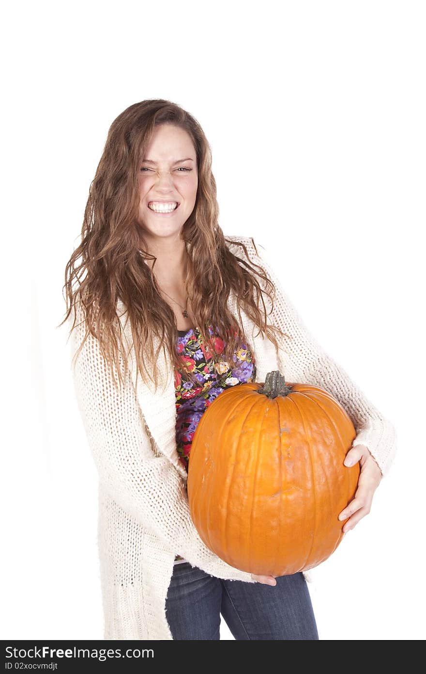 A woman is holding a large pumpkin. A woman is holding a large pumpkin.