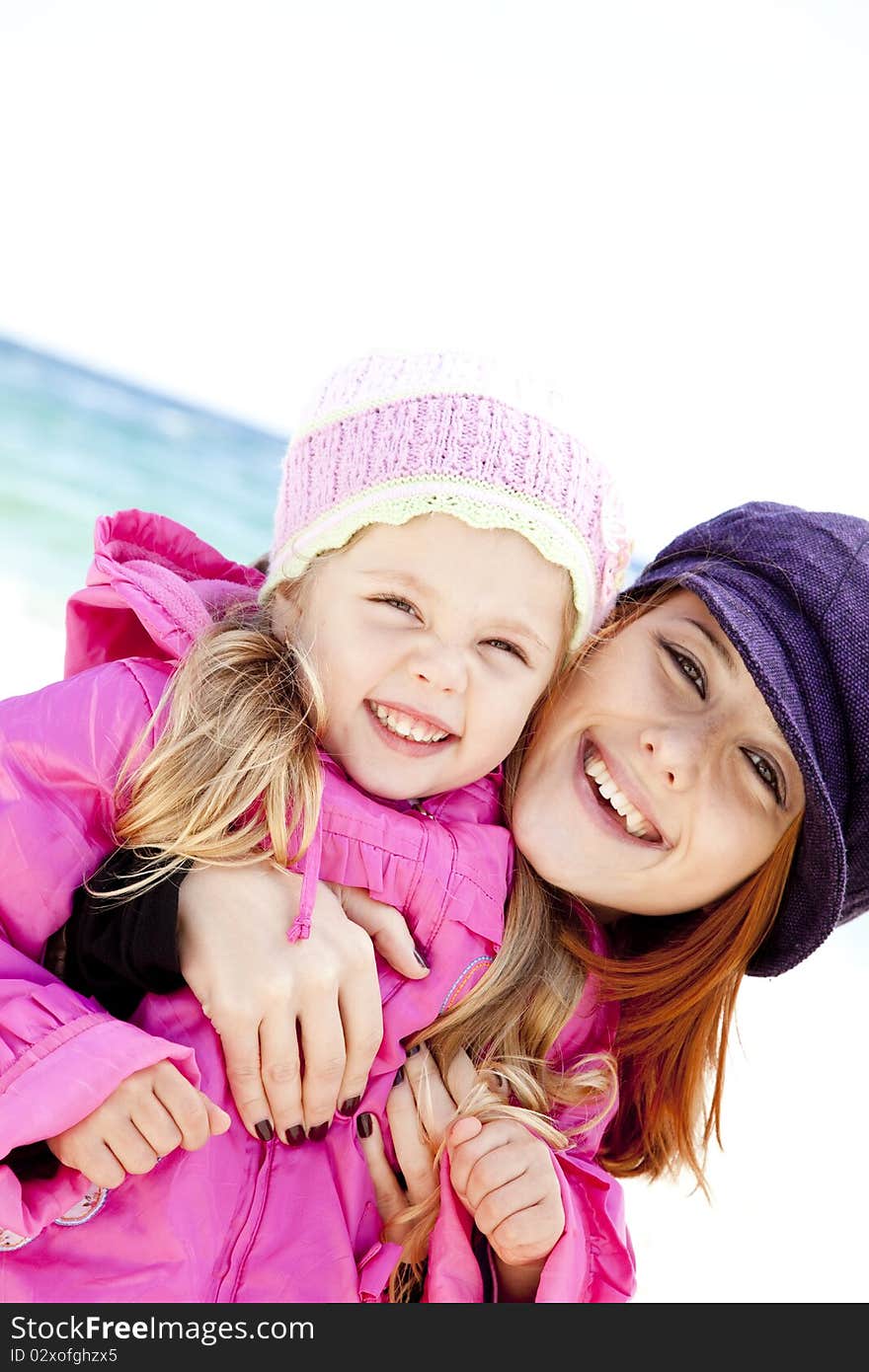 Two sisters 4 and 21 years old at the beach