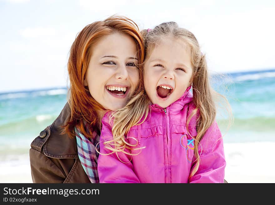 Two sisters 4 and 21 years old at the beach in sunny autumn day.