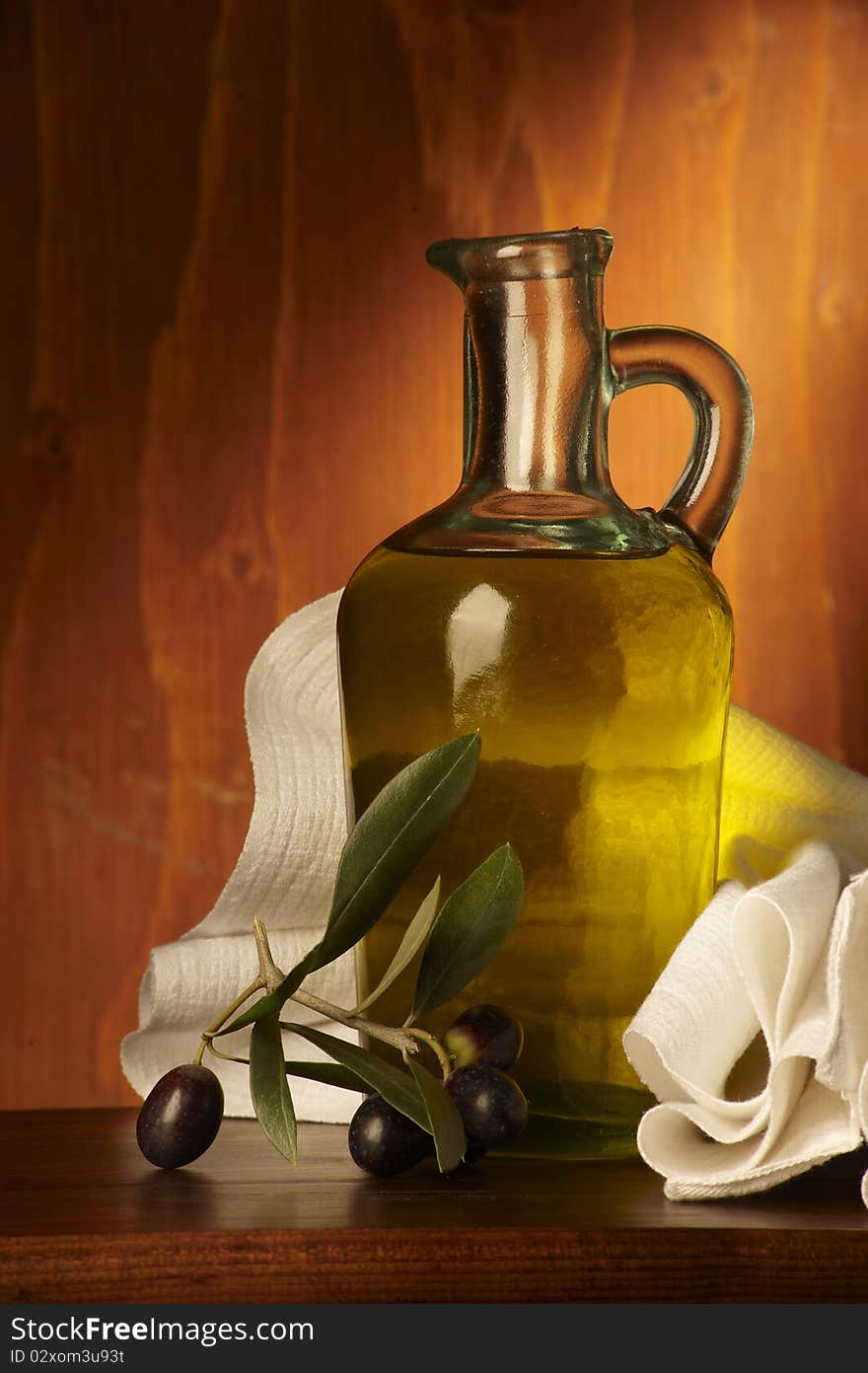 Bottle with olive oil on wood