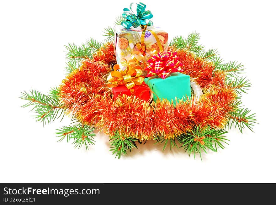 Christmas gifts on fur-tree branches isolated on a white background