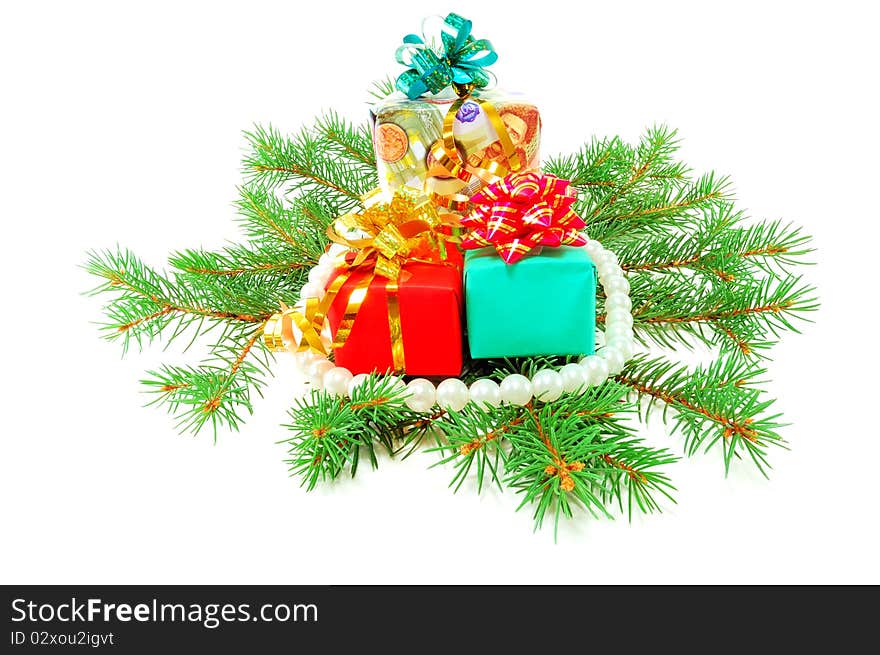 Christmas gifts on fur-tree branches isolated on a white background