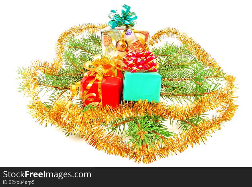 Christmas gifts on fur-tree branches isolated on a white background