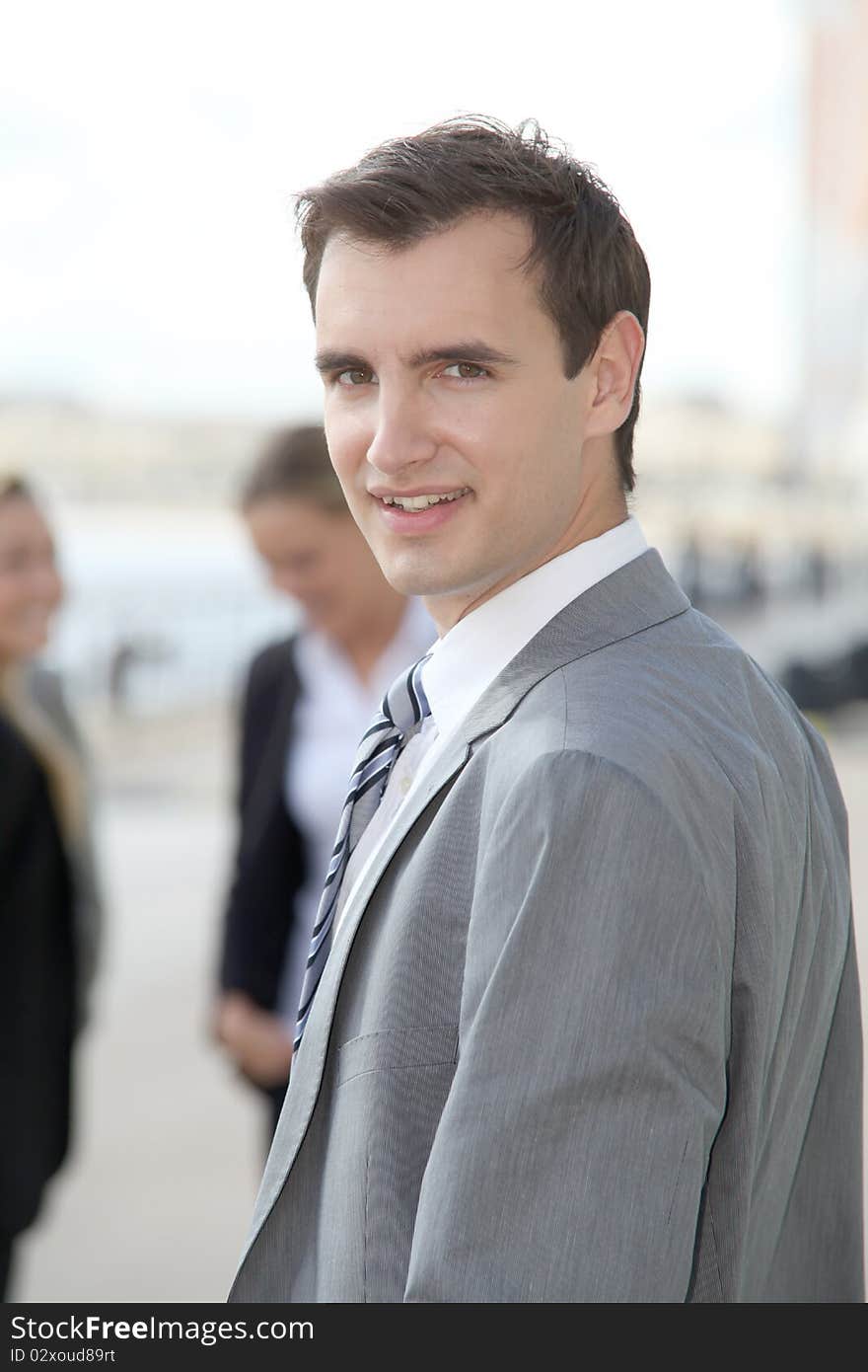 Businessman standing outdoors in the entrance of international fair. Businessman standing outdoors in the entrance of international fair