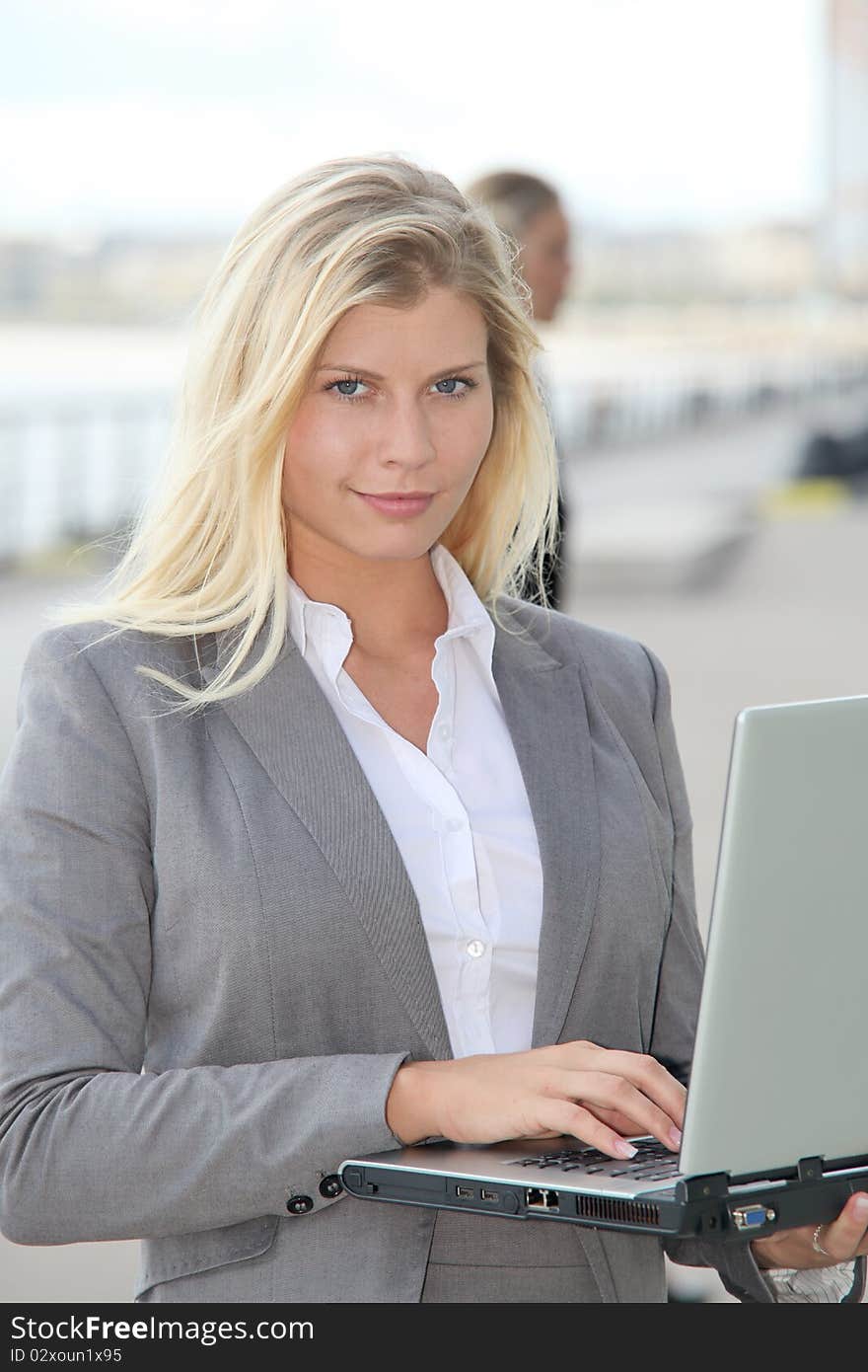 Blond businesswoman with laptop computer. Blond businesswoman with laptop computer