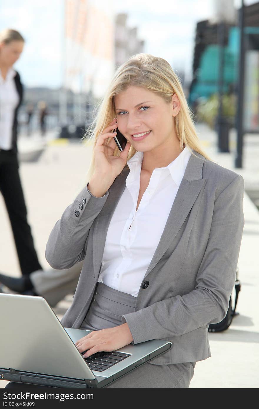 Blond businesswoman with laptop computer. Blond businesswoman with laptop computer