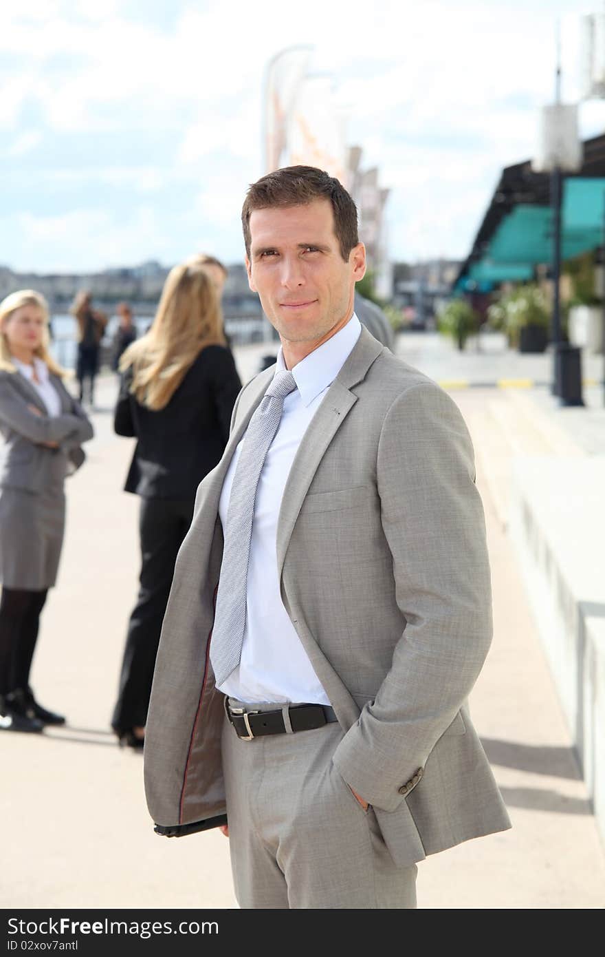 Businessman standing outdoors in the entrance of international fair. Businessman standing outdoors in the entrance of international fair