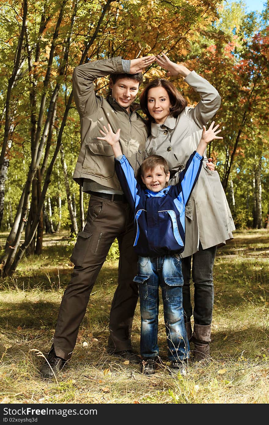 Happy family walking at the autumn park. Happy family walking at the autumn park.