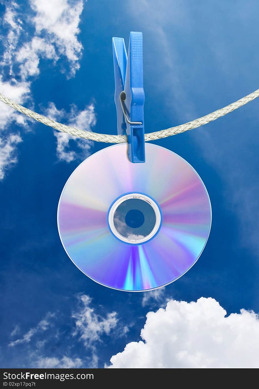 Cd on rope with clothes pin over blue sky