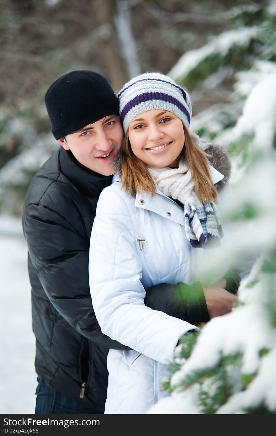 Beautiful couple in winter park.