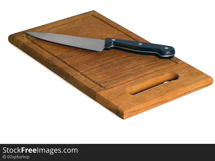 Kitchen knife lying on a wooden chopping board. Kitchen knife lying on a wooden chopping board