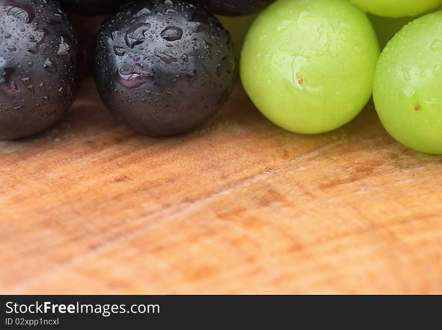 Grapes with water droplets on outdoor table, close-up with copy space. Grapes with water droplets on outdoor table, close-up with copy space