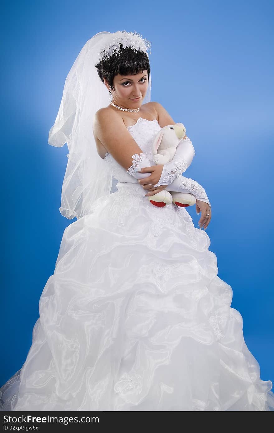 One happy and Beautiful bride on blue background. One happy and Beautiful bride on blue background.