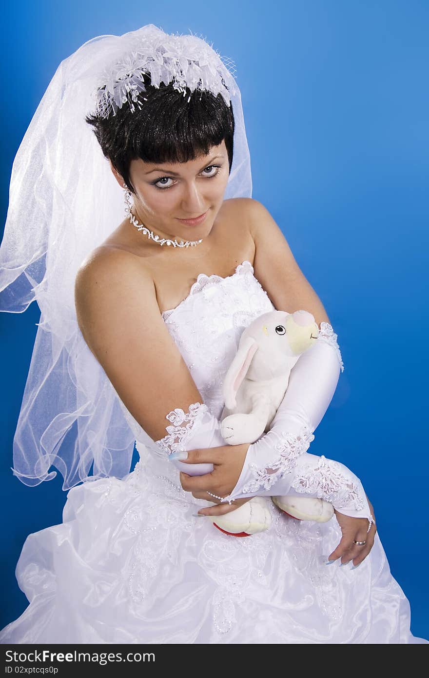 One happy and Beautiful bride on blue background. One happy and Beautiful bride on blue background.