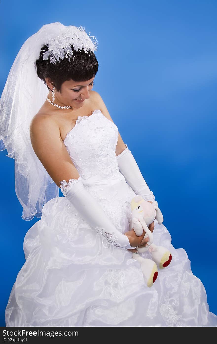 One happy and Beautiful bride on blue background. One happy and Beautiful bride on blue background.